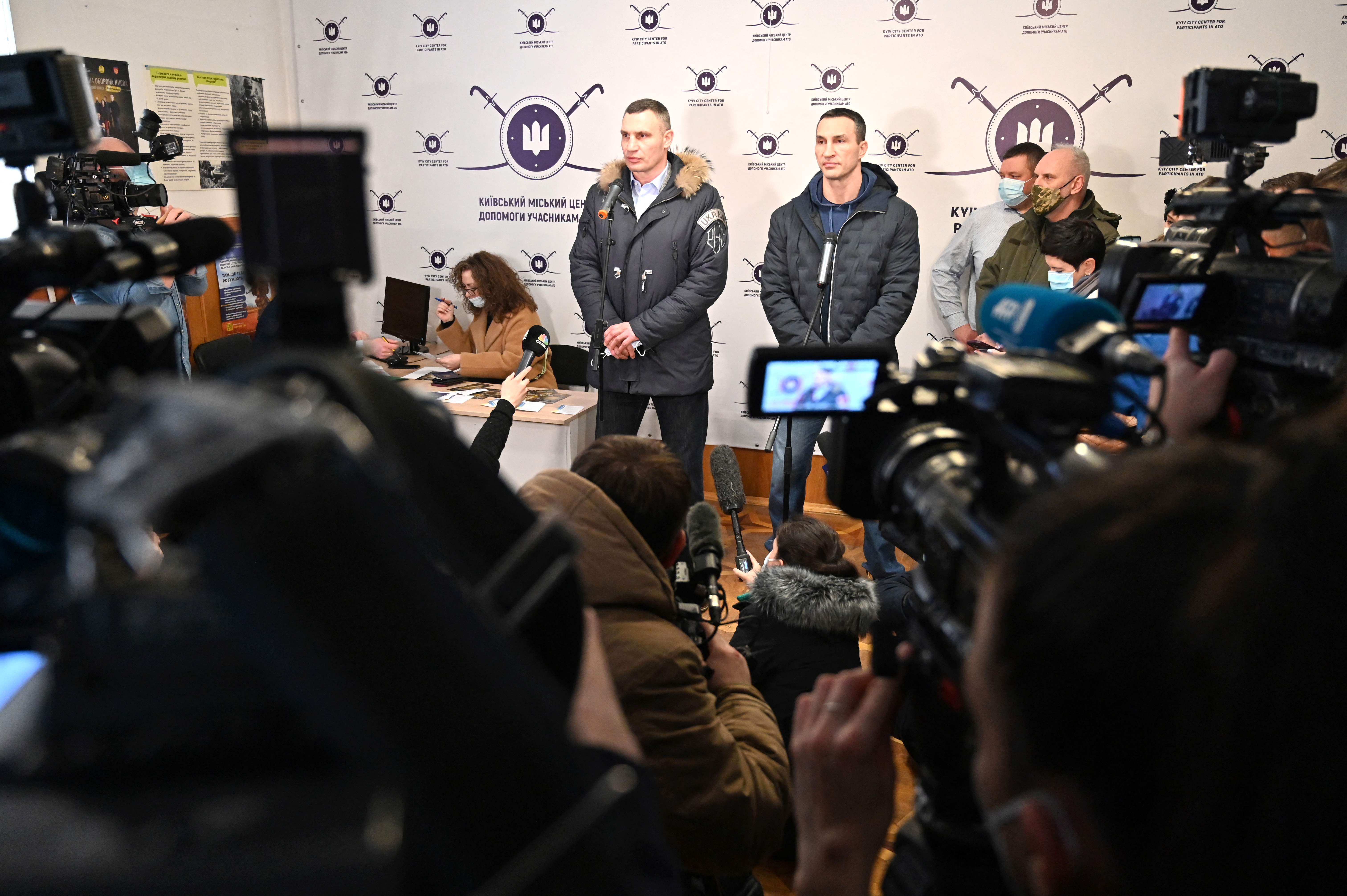 Vitali, left, and Wladimir Klitschko speak to the press at a volunteer recruitment center in Kyiv in early February.