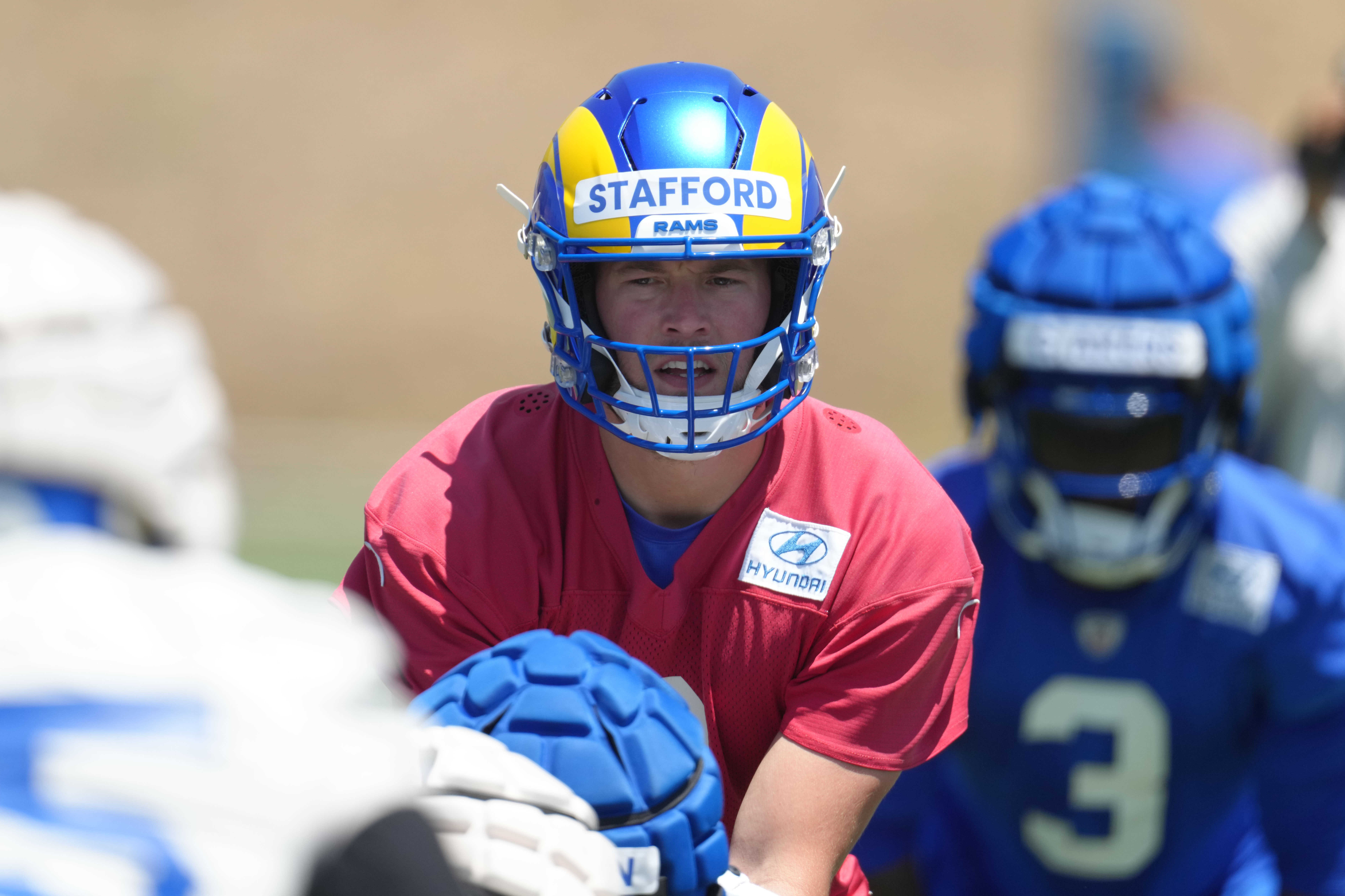Los Angeles Rams quarterback Matthew Stafford takes the snap during organized team activities at California Lutheran University on May 23.