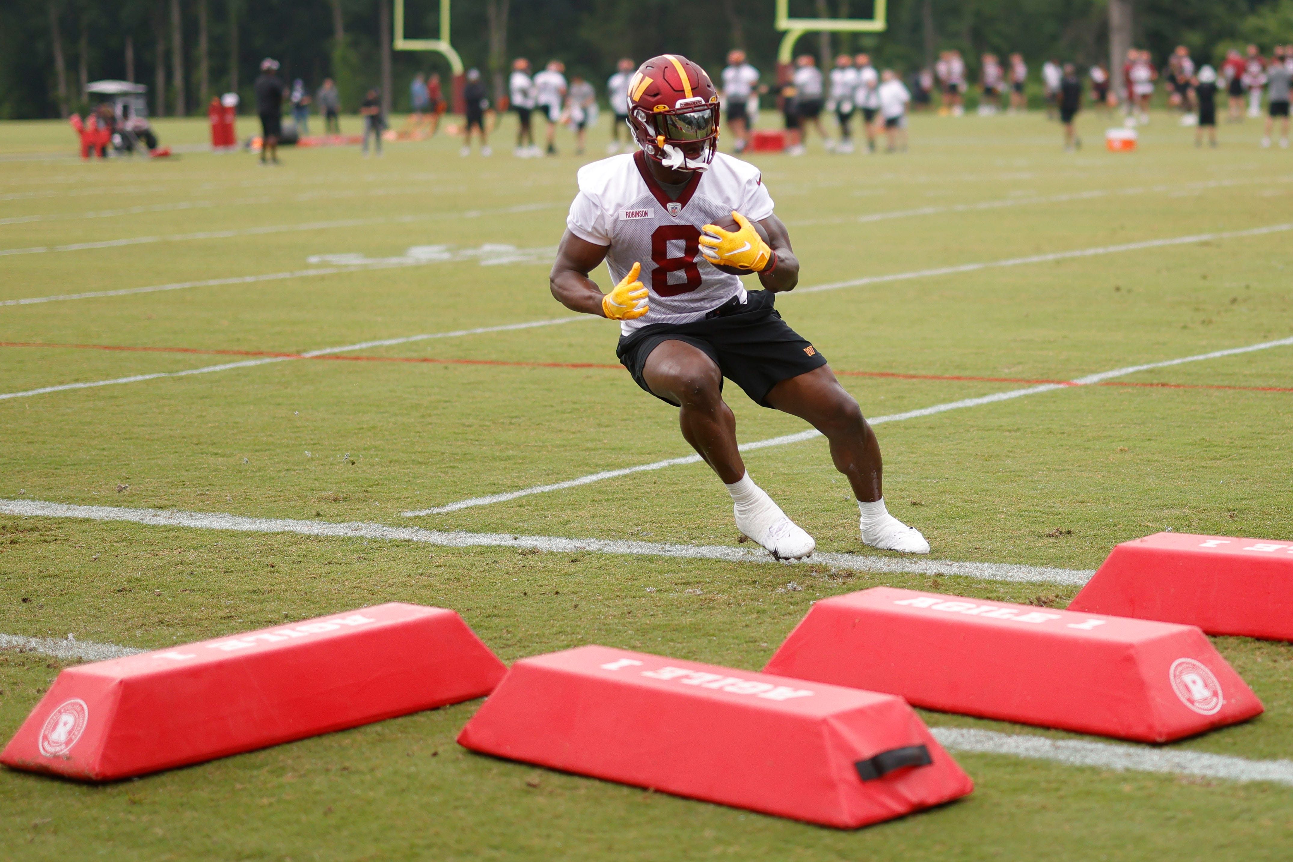 Washington Commanders running back Brian Robinson carries the ball during drills at minicamp on June 14.
